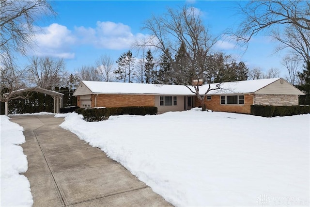 view of snow covered exterior with a carport