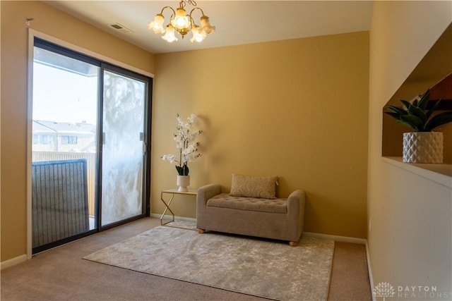 living area with baseboards, carpet floors, visible vents, and an inviting chandelier