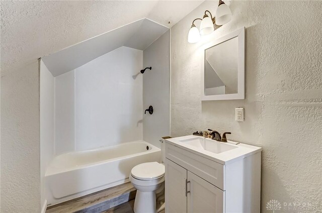 full bathroom featuring vanity, hardwood / wood-style floors, bathing tub / shower combination, and toilet