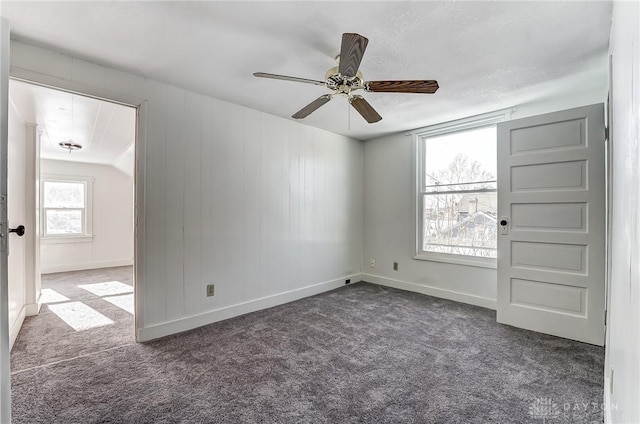 carpeted spare room with ceiling fan and a healthy amount of sunlight