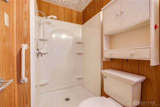 bathroom with walk in shower and toilet