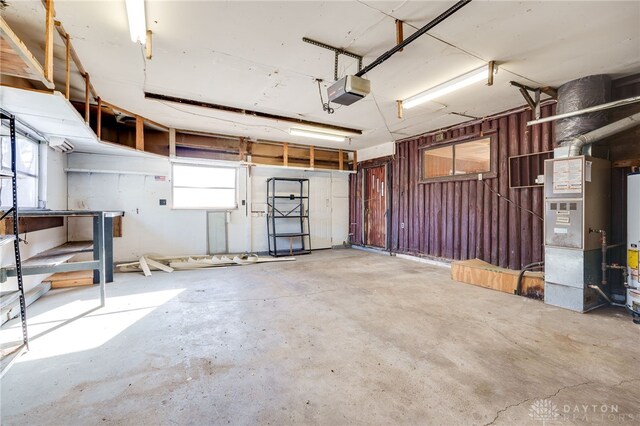 garage with a garage door opener and heating unit