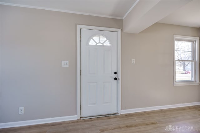 entryway featuring crown molding and light wood-type flooring