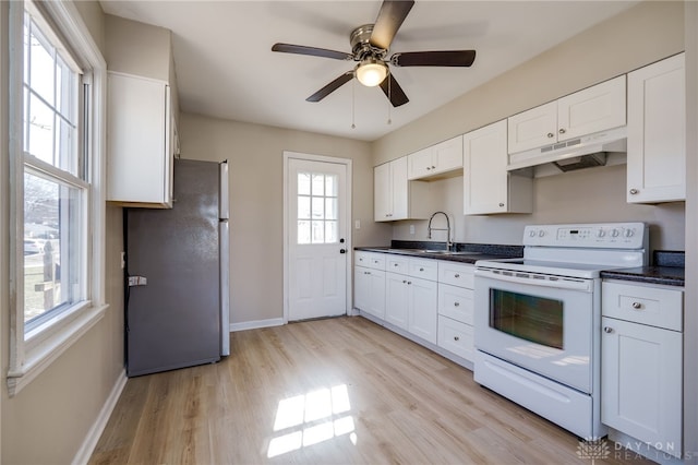 kitchen featuring white range with electric stovetop, sink, white cabinets, stainless steel fridge, and light hardwood / wood-style floors