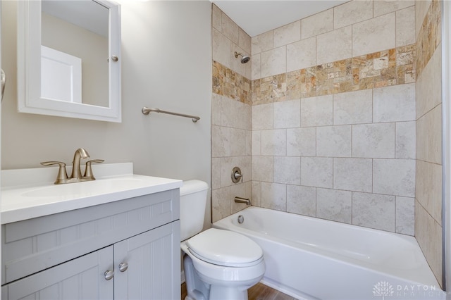 full bathroom with vanity, toilet, and tiled shower / bath combo