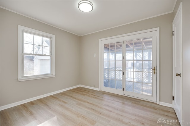 spare room featuring crown molding and light wood-type flooring