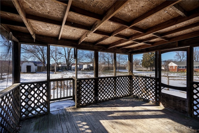 snow covered deck featuring a shed