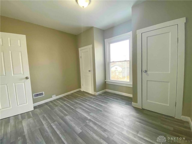 unfurnished bedroom with hardwood / wood-style flooring