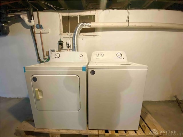 clothes washing area featuring washer and dryer