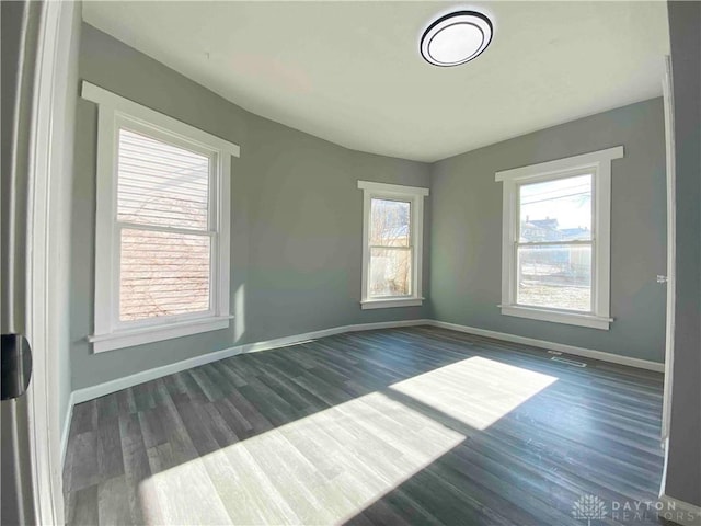 spare room with dark hardwood / wood-style floors