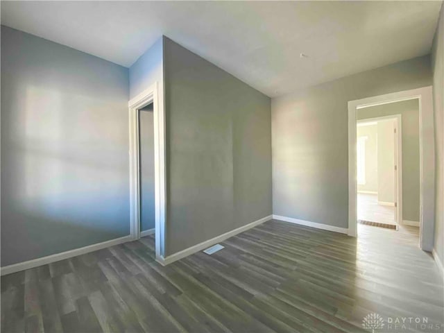 spare room with dark hardwood / wood-style flooring