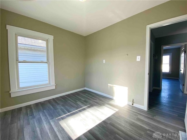 spare room featuring dark hardwood / wood-style floors