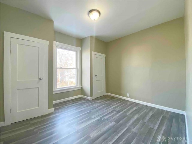 unfurnished bedroom featuring dark hardwood / wood-style flooring