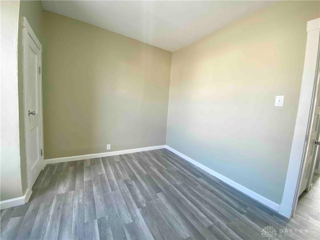 empty room featuring dark hardwood / wood-style flooring