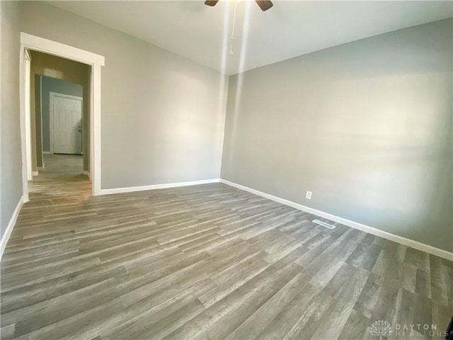 empty room with hardwood / wood-style flooring and ceiling fan