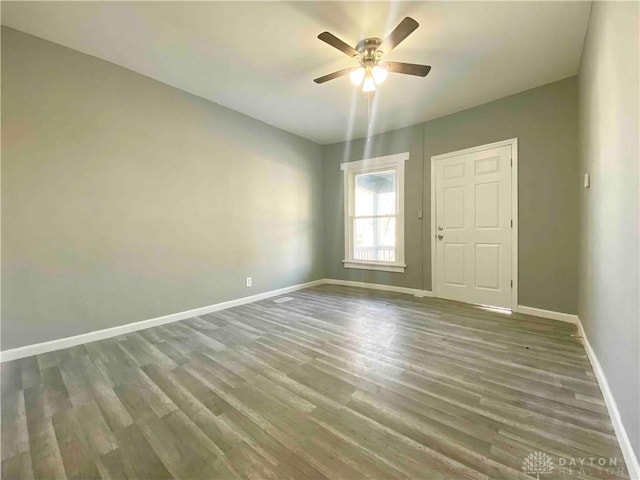 empty room with ceiling fan and wood-type flooring