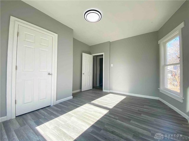 unfurnished bedroom featuring dark hardwood / wood-style floors