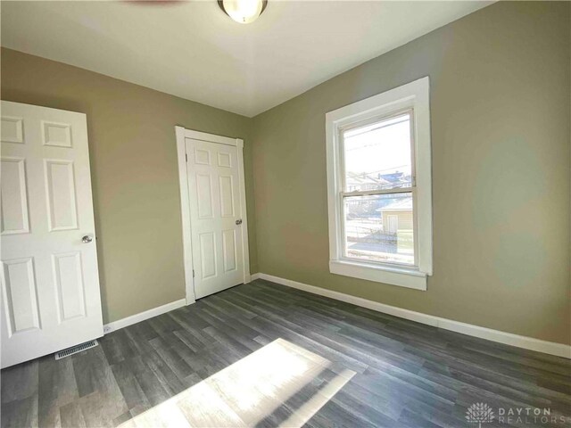 unfurnished bedroom featuring dark hardwood / wood-style floors