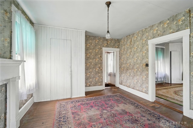 120 E State Route 73, Springboro, OH 45066 - unfurnished dining area featuring hardwood / wood-style flooring, wallpapered walls, a fireplace, and baseboards