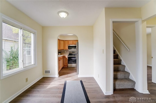 kitchen with appliances with stainless steel finishes and light hardwood / wood-style flooring