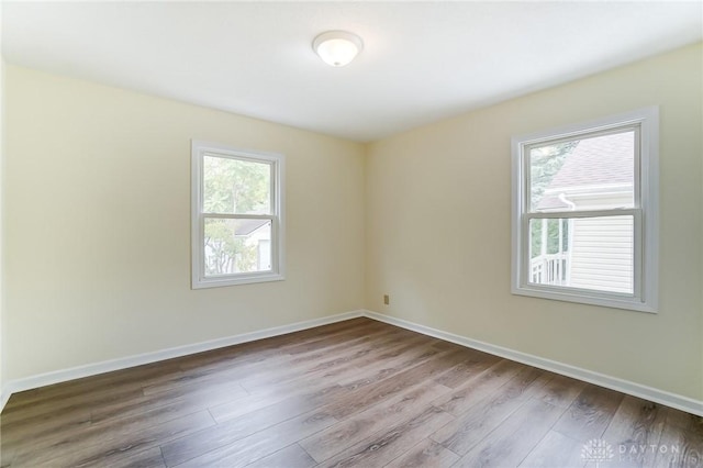 spare room featuring wood-type flooring