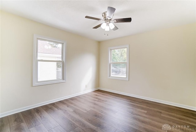 unfurnished room with dark wood-type flooring and ceiling fan