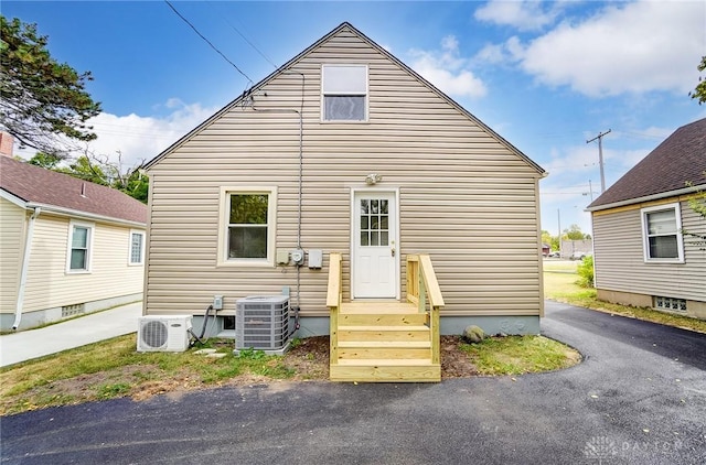 back of house featuring central AC unit and ac unit