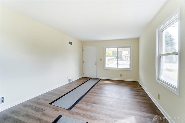 unfurnished room with light wood-type flooring