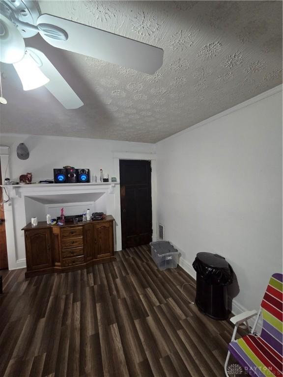 interior space featuring dark hardwood / wood-style flooring and a textured ceiling