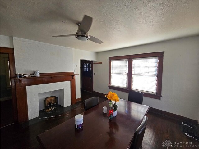 dining room featuring ceiling fan, dark hardwood / wood-style flooring, and a textured ceiling