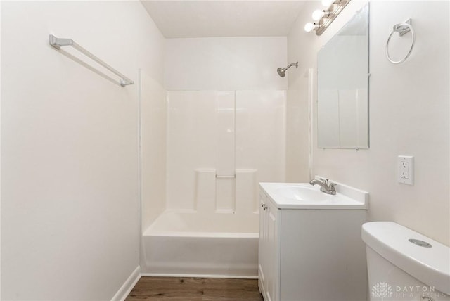 full bathroom with vanity, wood-type flooring, shower / tub combination, and toilet