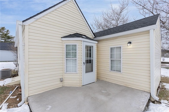 exterior space with central AC unit and a patio area