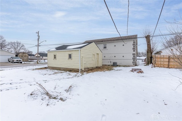 view of snow covered back of property