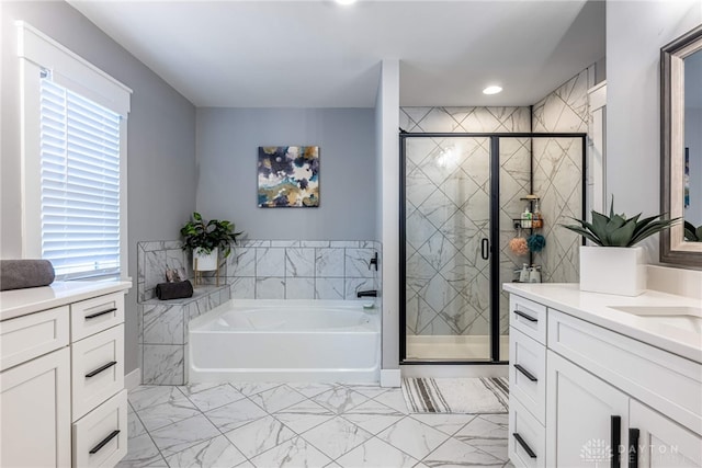 bathroom featuring vanity, a healthy amount of sunlight, and plus walk in shower