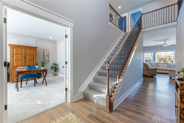 staircase with hardwood / wood-style floors