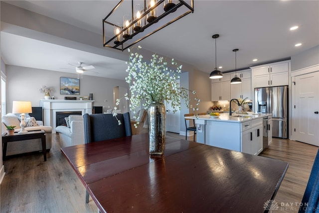 dining room with dark wood-type flooring, ceiling fan, and sink