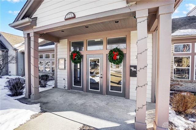 view of snow covered property entrance