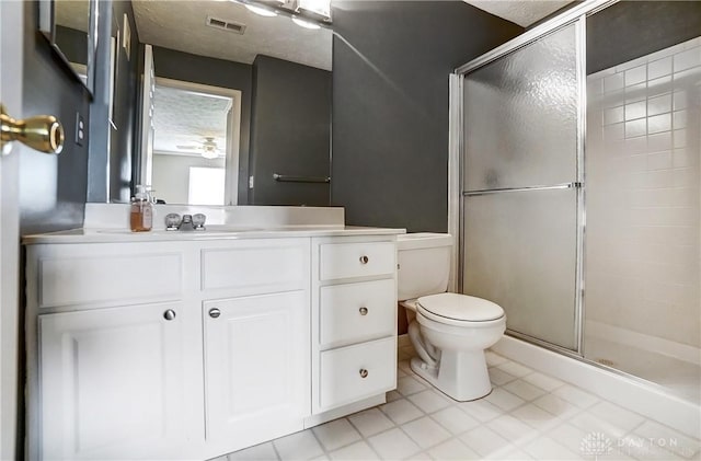 bathroom with vanity, toilet, and an enclosed shower