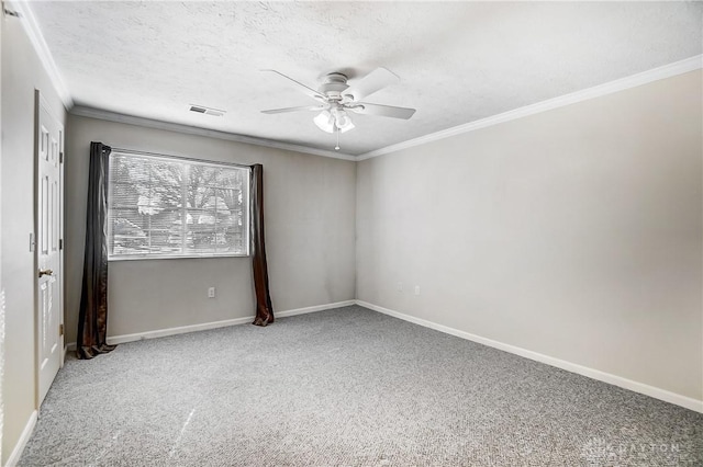 carpeted spare room featuring ceiling fan, ornamental molding, and a textured ceiling