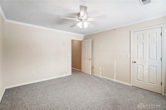 unfurnished bedroom featuring crown molding, carpet floors, a textured ceiling, and ceiling fan