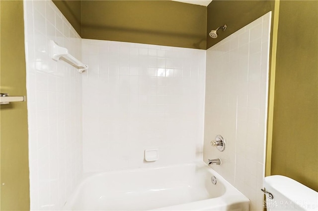 bathroom featuring bathtub / shower combination and toilet