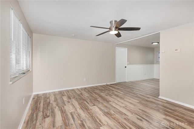 empty room with ceiling fan and light wood-type flooring