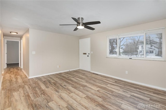 spare room featuring light hardwood / wood-style floors and ceiling fan