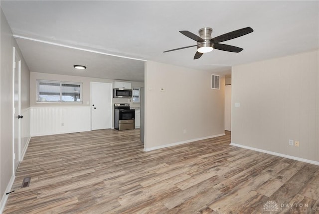 unfurnished living room with ceiling fan and light hardwood / wood-style floors