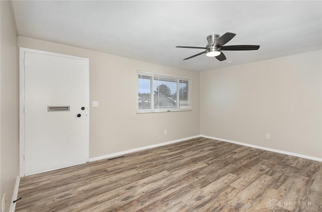 unfurnished room featuring hardwood / wood-style floors and ceiling fan