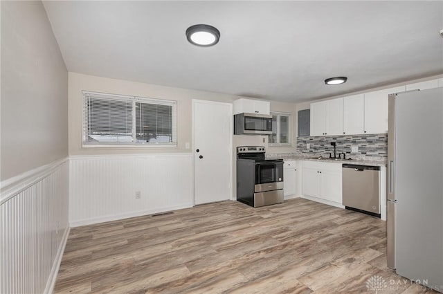 kitchen with sink, stainless steel appliances, and white cabinets