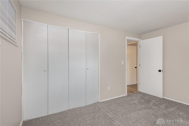 unfurnished bedroom with carpet floors and a closet