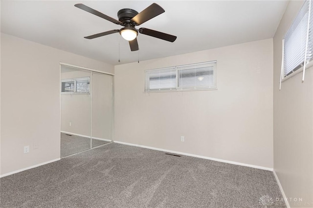 unfurnished bedroom featuring carpet flooring, ceiling fan, and a closet