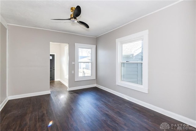 empty room featuring ceiling fan, ornamental molding, and dark hardwood / wood-style floors