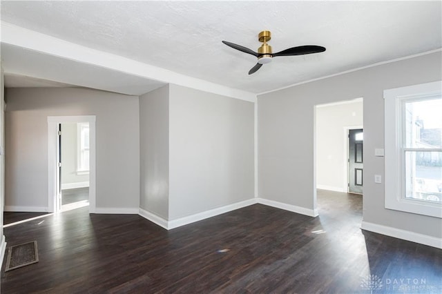 empty room with ceiling fan and dark hardwood / wood-style flooring